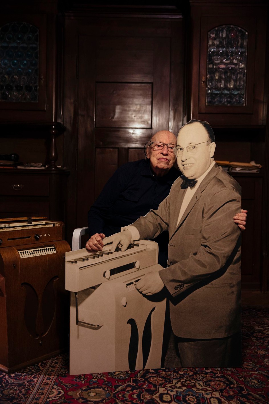 Jean-Jacques Perrey with cardboard cutout of himself and his Ondioline from 55 years earlier, at home in Lausanne, Switzerland, November 2015. Photograph by Cybele Malinowski.